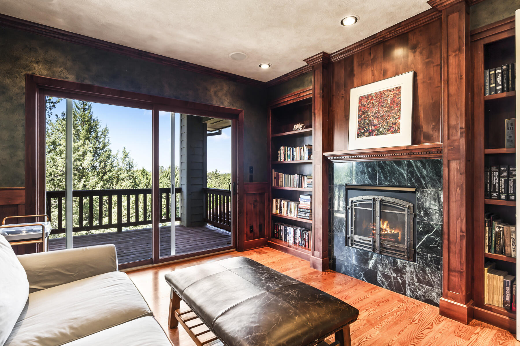 61445 Gosney Road Bend, OR 97702 - Photo 16 of 83 a living room with furniture a bookshelf and a large window