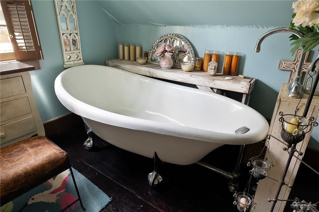 1803 North Bryan Road Mission, TX 78572 - Photo 16 of 30 Freestanding clawfoot tub with a gooseneck faucet, set against a light blue wall
