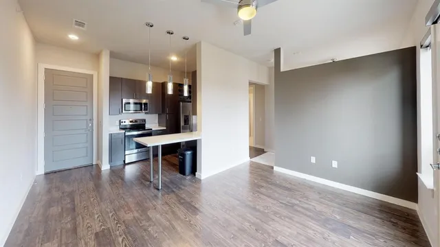 a view of kitchen with cabinets and wooden floor