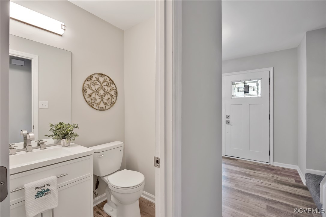 11202 Heathstead Road Chester, VA 23831 - Photo 20 of 50 Half bathroom featuring toilet, wood finished floo