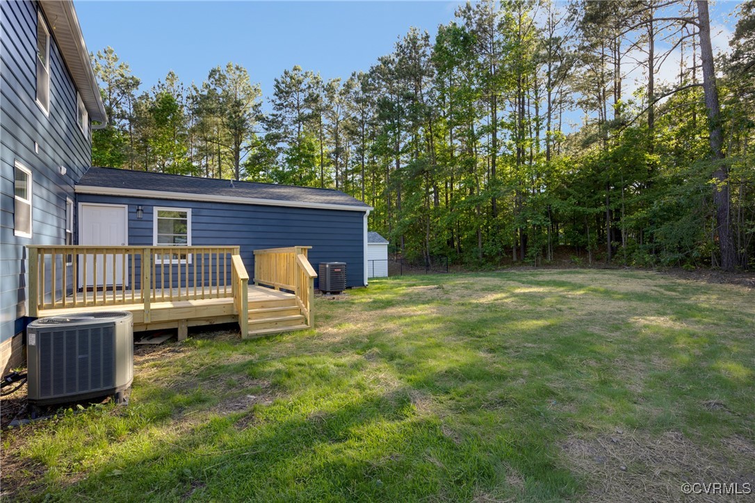11202 Heathstead Road Chester, VA 23831 - Photo 40 of 50 View of yard featuring central AC unit and a deck