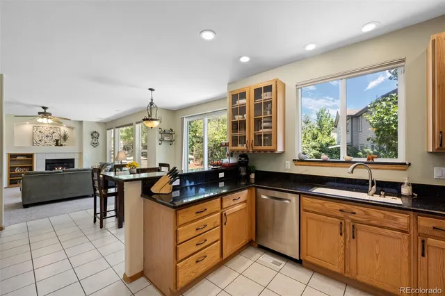 a kitchen with sink refrigerator and cabinets
