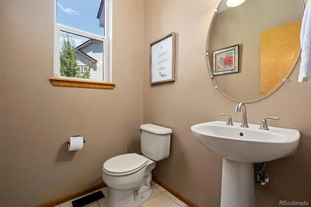 a kitchen with a sink a refrigerator and cabinets