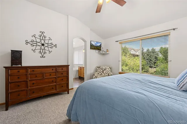 a bedroom with a large bed and a painting on the wall