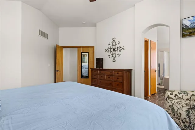 a spacious bathroom with a granite countertop double vanity sink a mirror a bathtub and