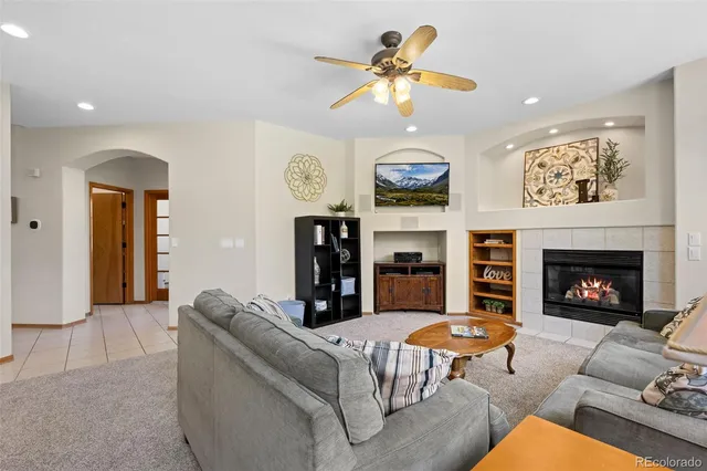 a living room with furniture kitchen view and a fireplace