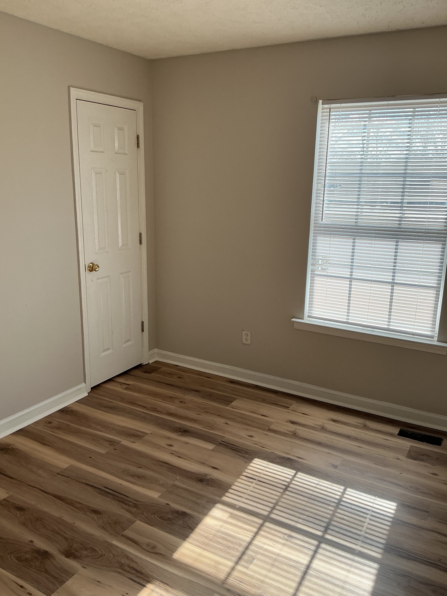 1431 Benley Street Murfreesboro, TN 37130 - Photo 8 of 8 a view of an empty room with wooden floor and a window