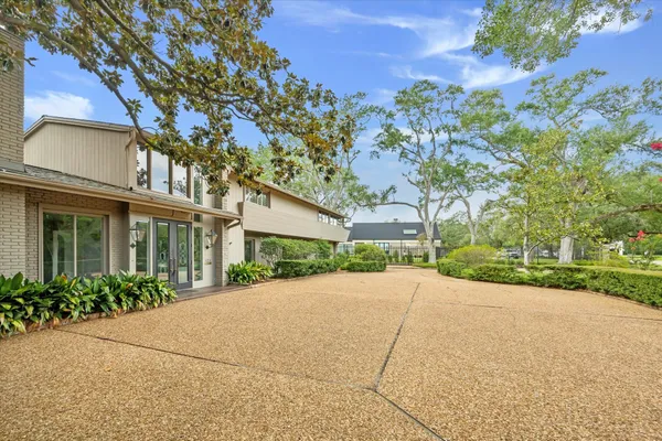 a view of a house with a tree in front of it