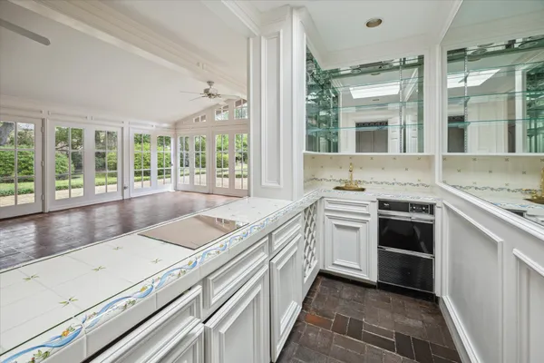 a open kitchen with granite countertop a sink stove and cabinets