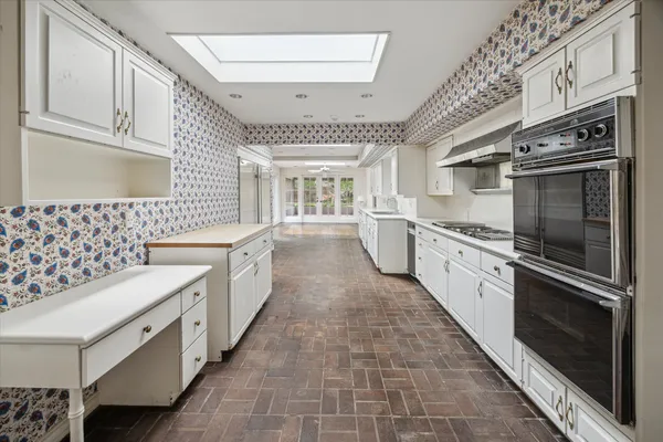 a kitchen with stainless steel appliances granite countertop a stove and a sink