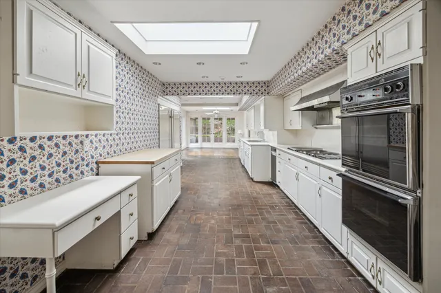 a kitchen with stainless steel appliances granite countertop a stove and a sink