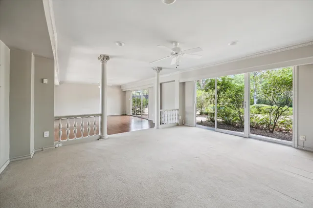 en empty room with windows and outdoor view