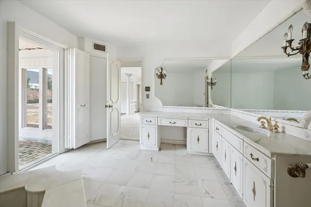 a bathroom with a granite countertop sink and a shower
