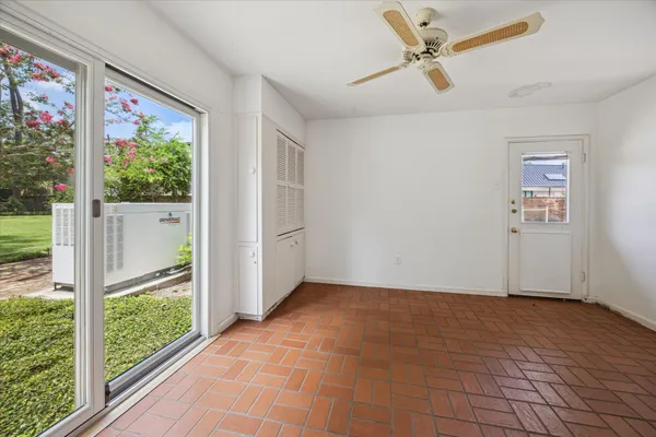 a view of a room with wooden floor and windows