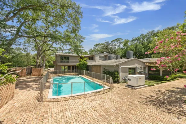 a view of yard with swimming pool and green space