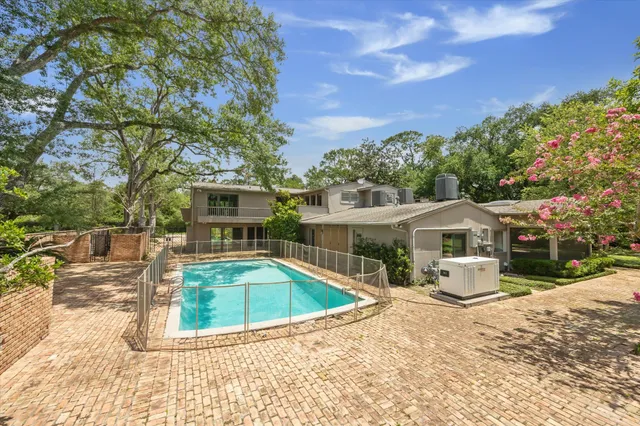 a view of yard with swimming pool and green space