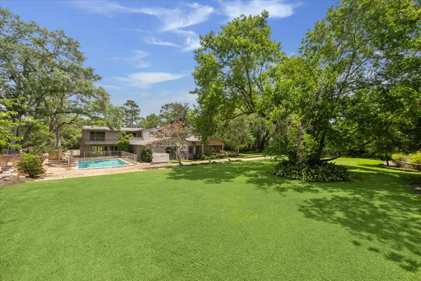 an aerial view of a house with a yard