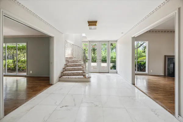 a view of an entryway with wooden floor and windows
