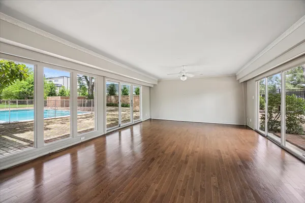 a view of wooden floor and windows in a room