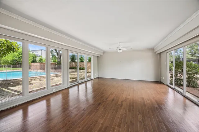 a view of wooden floor and windows in a room