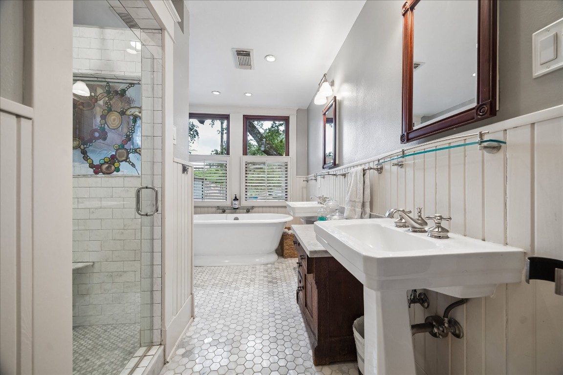 1705 Haver Street Houston, TX 77006 - Photo 16 of 31 Primary Bath with marble finishes, double sinks, soaking tub, and custom dual head shower with stained glass