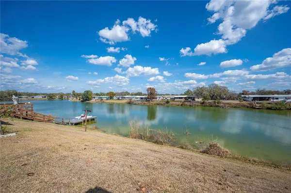 a view of a lake in between two and trees