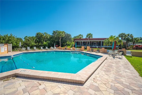 a view of swimming pool with chairs