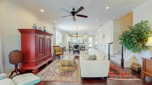 a living room with furniture and a chandelier
