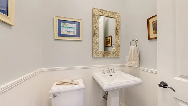 a bathroom with a sink a toilet and mirror