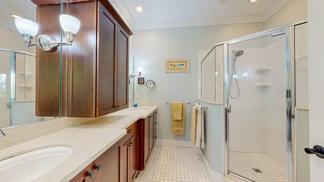 a bathroom with a double vanity sink mirror and shower