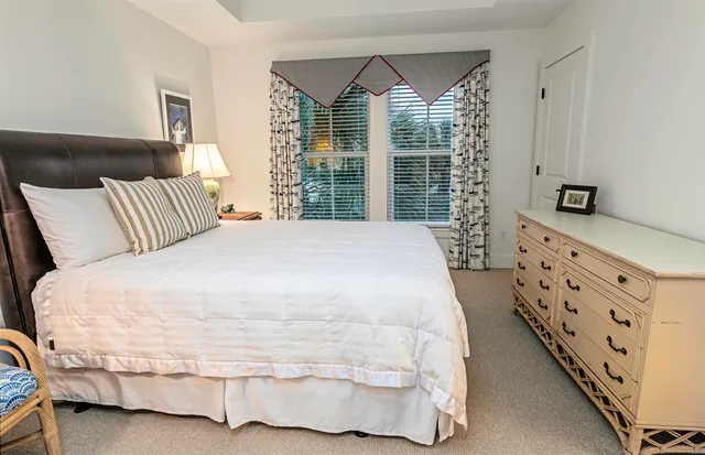 a large white bed in a white room