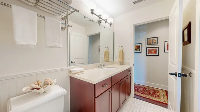 a bathroom with a sink vanity and a mirror