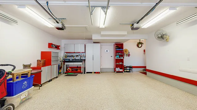 a view of a hallway with wooden floor and windows