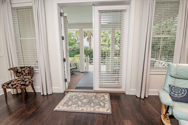 a balcony with wooden floor table and chairs