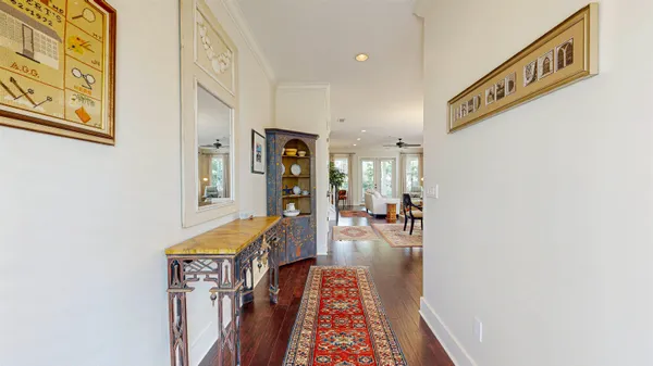 a kitchen with stainless steel appliances granite countertop a stove a sink and a wooden floor