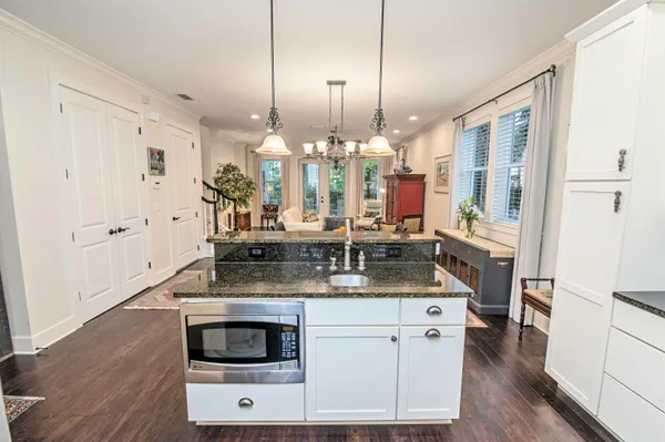 a kitchen with stainless steel appliances a sink a stove a refrigerator and cabinets
