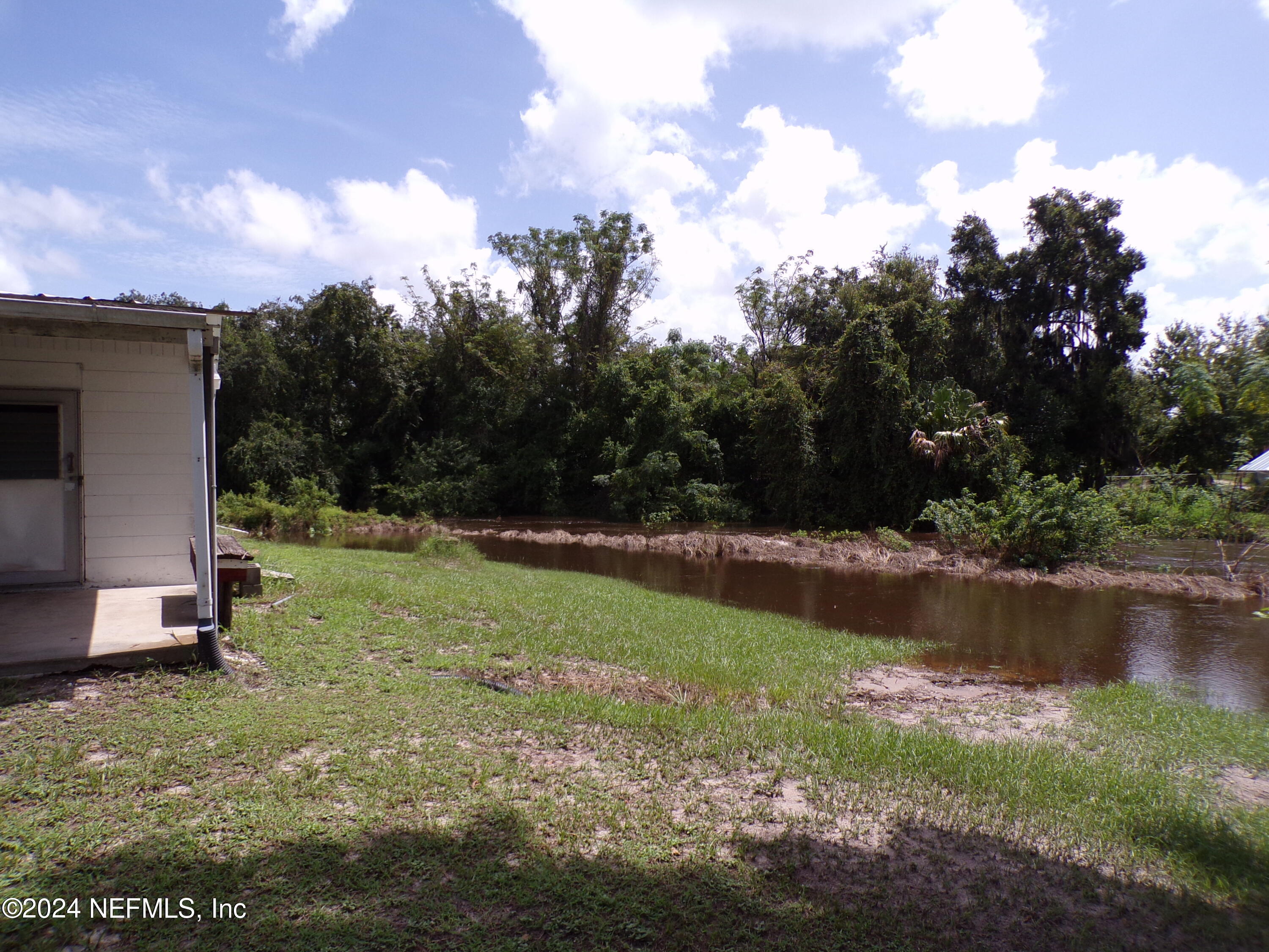 10642 East Bay Road Gibsonton, FL 33534 - Photo 19 of 32 a view of a lake with a yard
