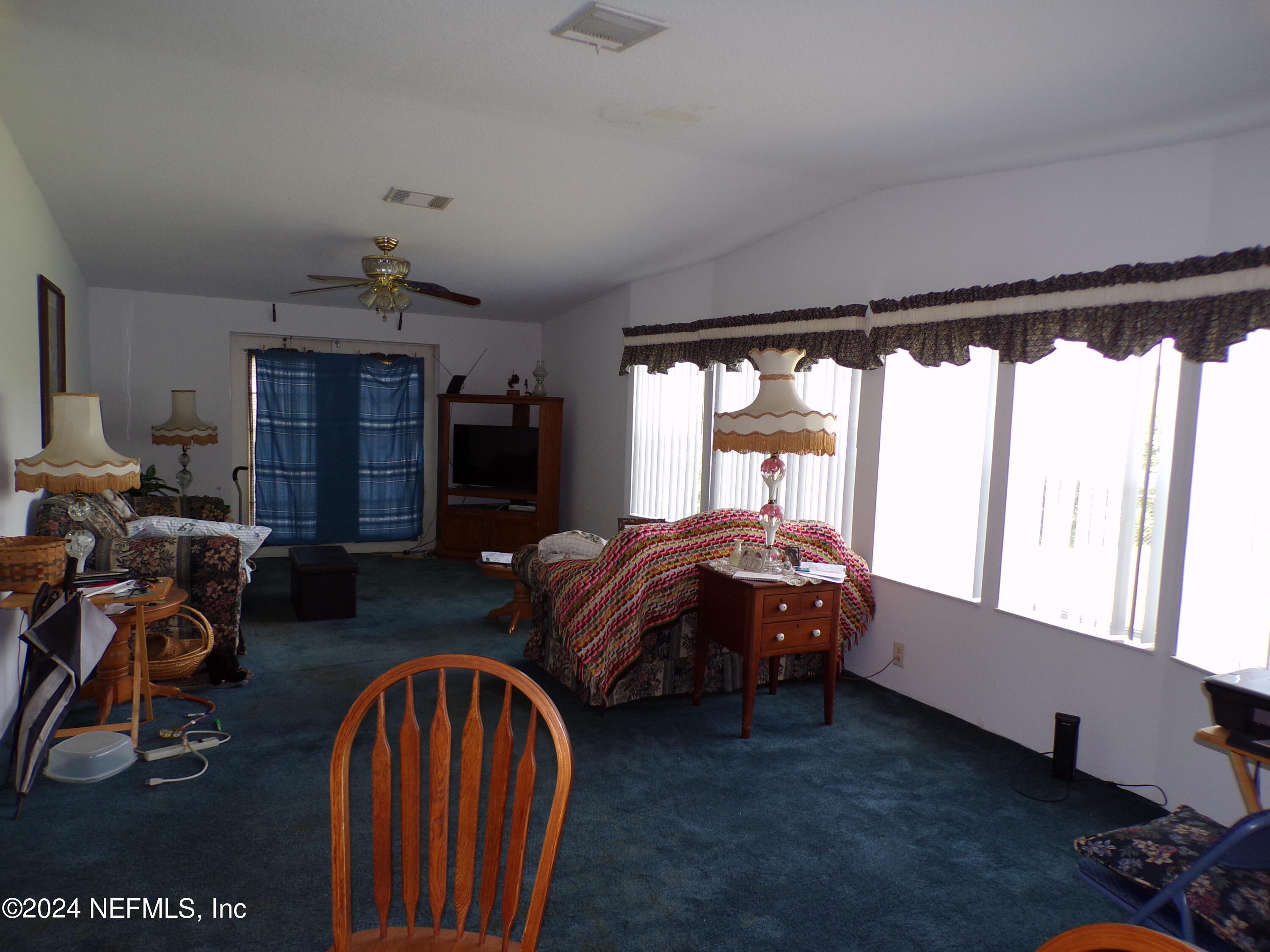 10642 East Bay Road Gibsonton, FL 33534 - Photo 7 of 32 a bedroom with bed and a large window