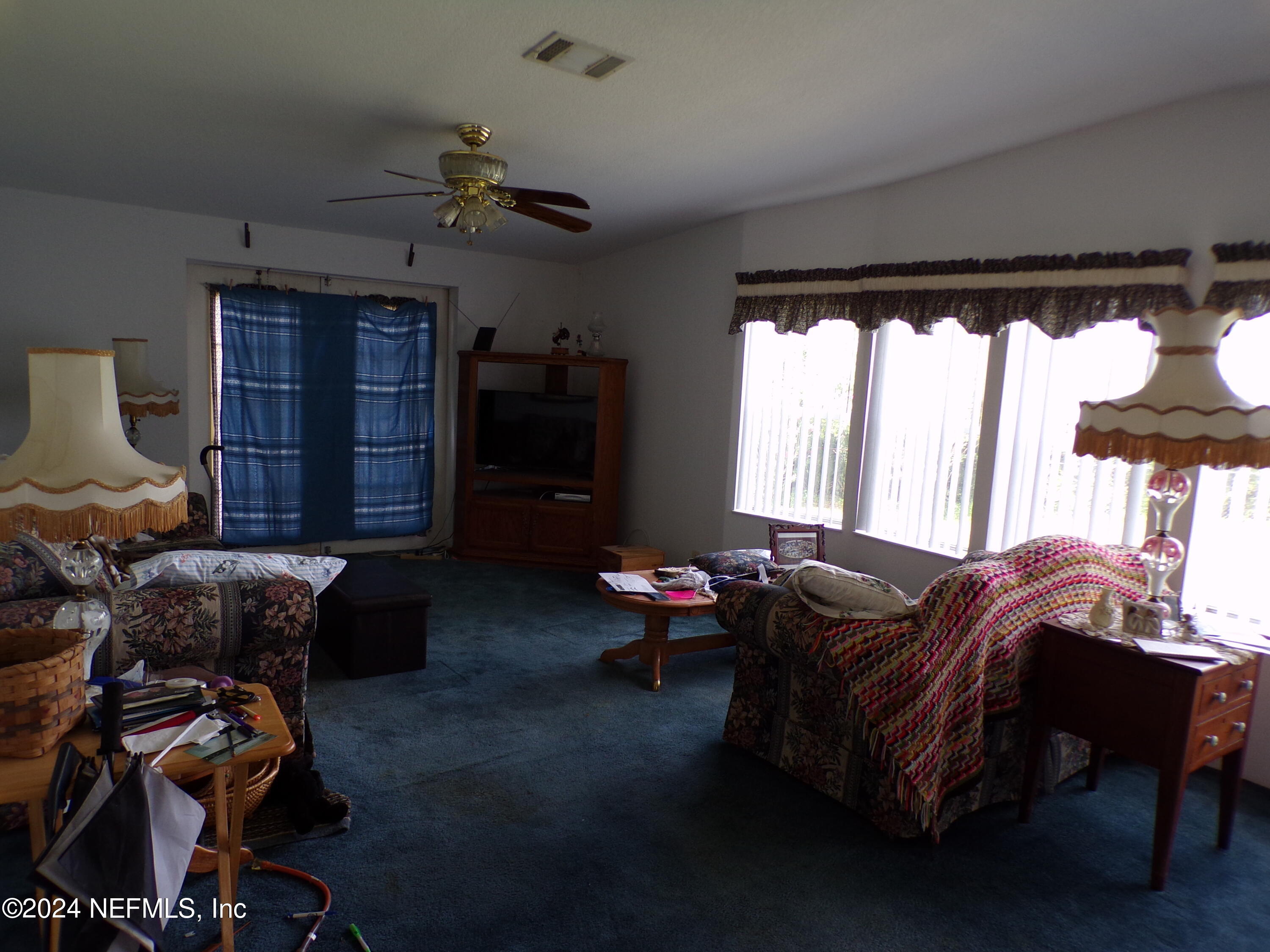 10642 East Bay Road Gibsonton, FL 33534 - Photo 8 of 32 a living room with furniture and a window