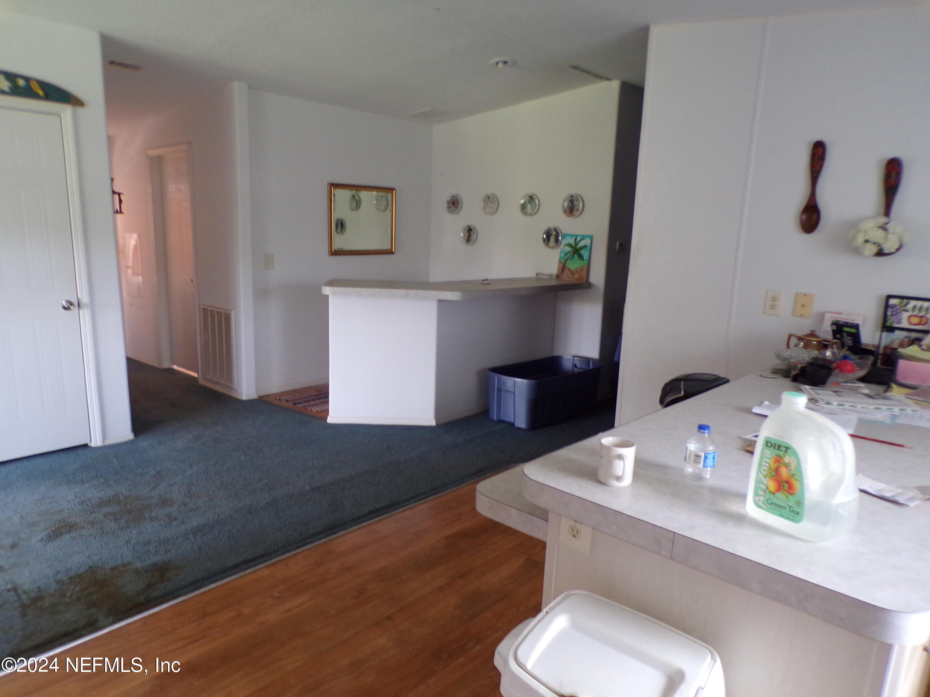 10642 East Bay Road Gibsonton, FL 33534 - Photo 10 of 32 a bathroom with a sink toilet and painting on the wall