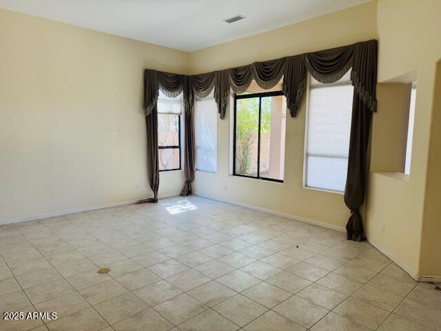 4843 East Estevan Road Phoenix, AZ 85054 - Photo 4 of 10 a view of an empty room with a fireplace and a window