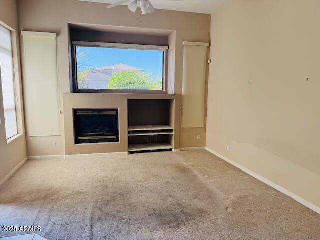 4843 East Estevan Road Phoenix, AZ 85054 - Photo 5 of 10 a view of an empty room with a fireplace and a window
