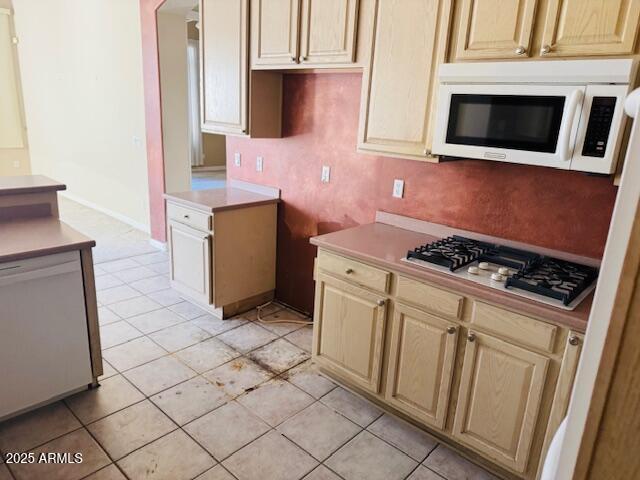 4843 East Estevan Road Phoenix, AZ 85054 - Photo 7 of 10 a kitchen with stainless steel appliances a stove microwave and cabinets