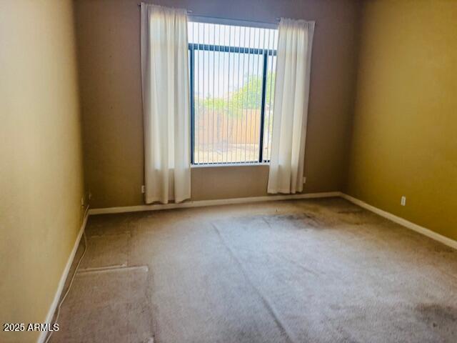 4843 East Estevan Road Phoenix, AZ 85054 - Photo 9 of 10 an empty room with a empty space and a window