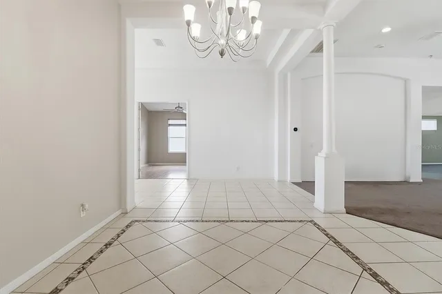 a view of a kitchen with a stove cabinets a ceiling fan and a large window