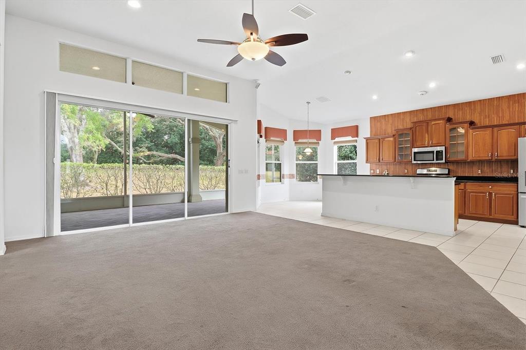 1683 North Shadowview Path Hernando, FL 34442 - Photo 15 of 56 a view of a kitchen with a stove cabinets a ceiling fan and a large window