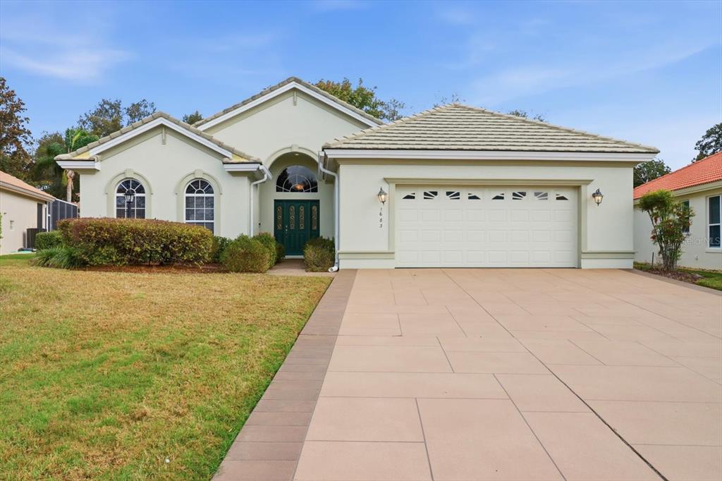 1683 North Shadowview Path Hernando, FL 34442 - Photo 2 of 56 a front view of a house with a yard and garage