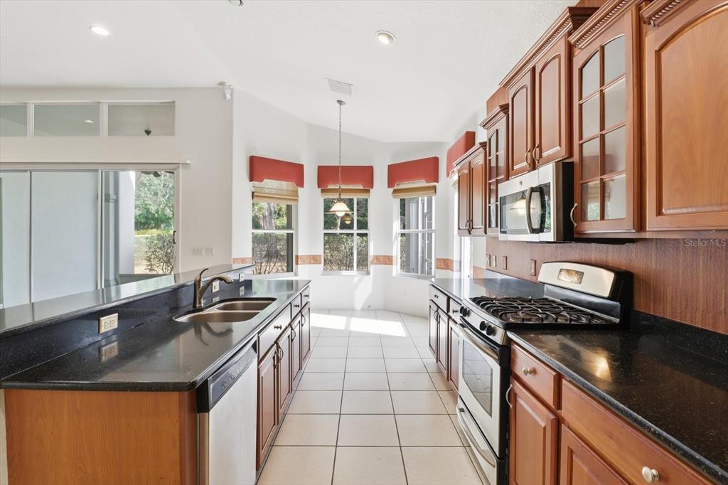 1683 North Shadowview Path Hernando, FL 34442 - Photo 21 of 56 a kitchen with stainless steel appliances a sink stove and cabinets