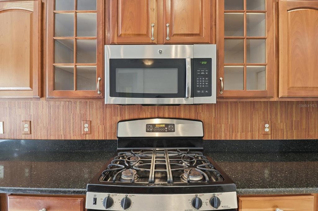1683 North Shadowview Path Hernando, FL 34442 - Photo 22 of 56 a kitchen with granite countertop a stove top oven cabinetry and granite counter tops