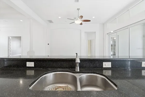 a bedroom with a bed and a chandelier fan